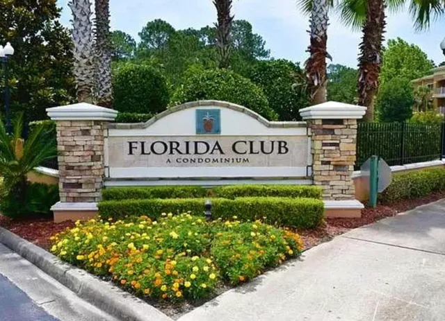 a view of sign board with flower around