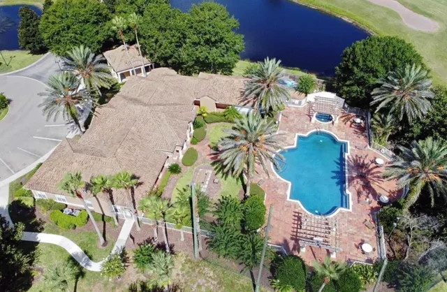 an aerial view of a house with a yard