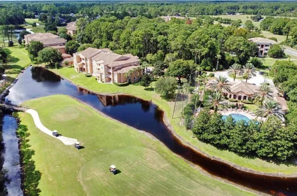 an aerial view of a house with a yard basket ball court and outdoor seating