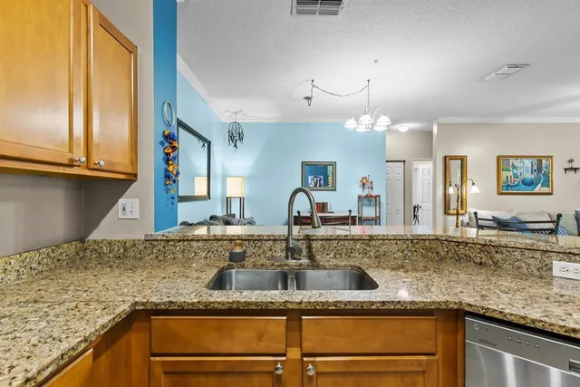 a kitchen with granite countertop a sink and a stove