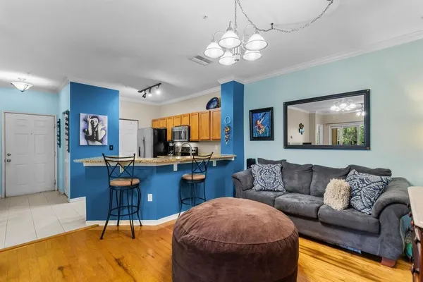 a living room with furniture a dining table and kitchen view