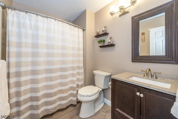 a bathroom with a toilet a sink and a mirror