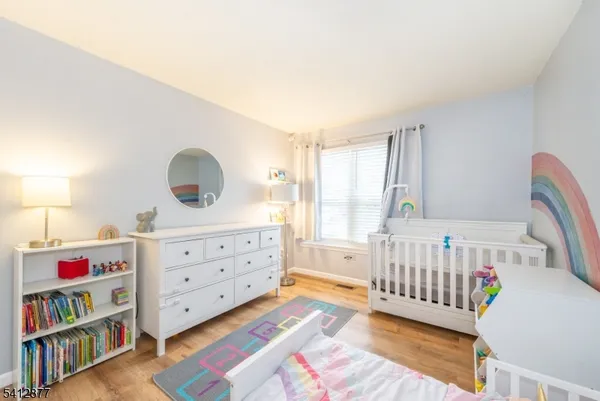 a bedroom with furniture and a baby crib
