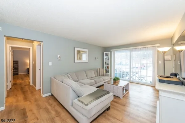 a living room with furniture and a large window with outer view