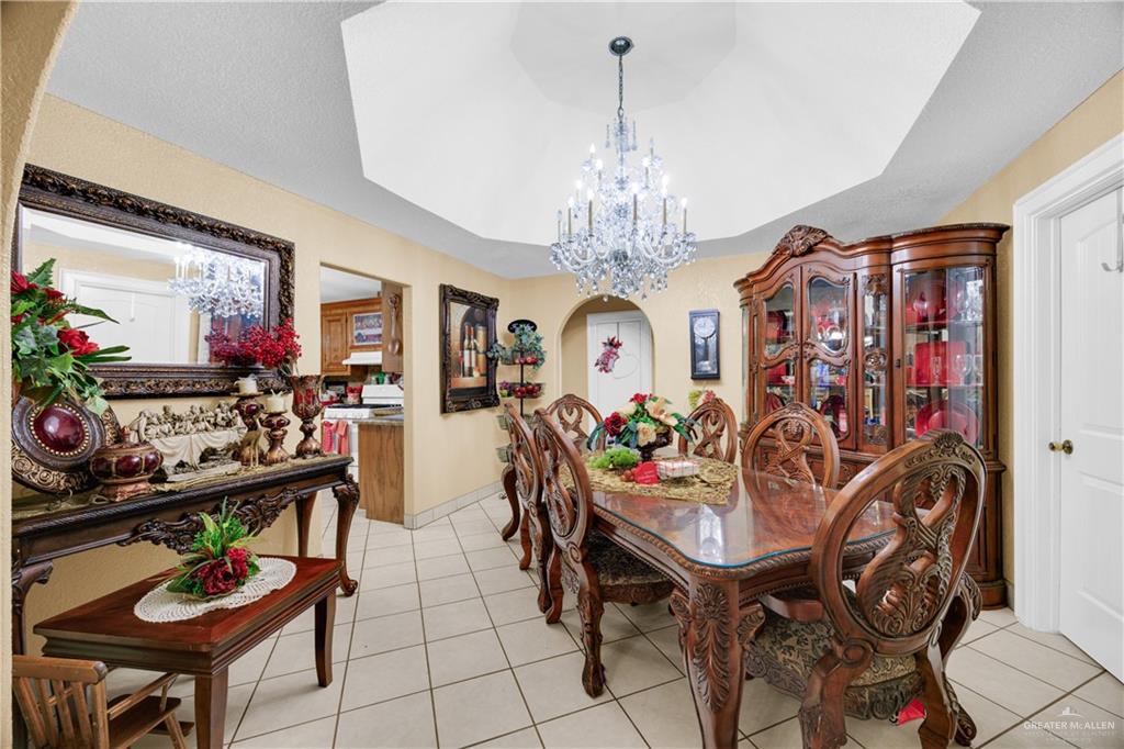 695 El Paisano Road Rio Grande City, TX 78582 - Photo 9 of 30 Dining room featuring suspended lighting and light tile patterned floors