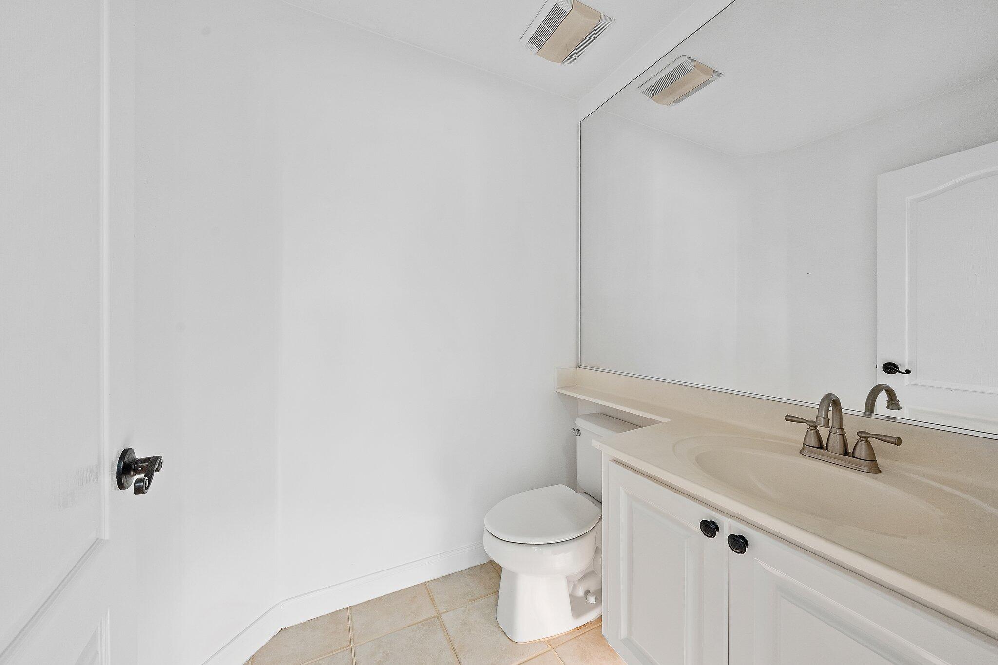 304 Legare Court Jupiter, FL 33458 - Photo 17 of 38 a bathroom with a sink and a toilet