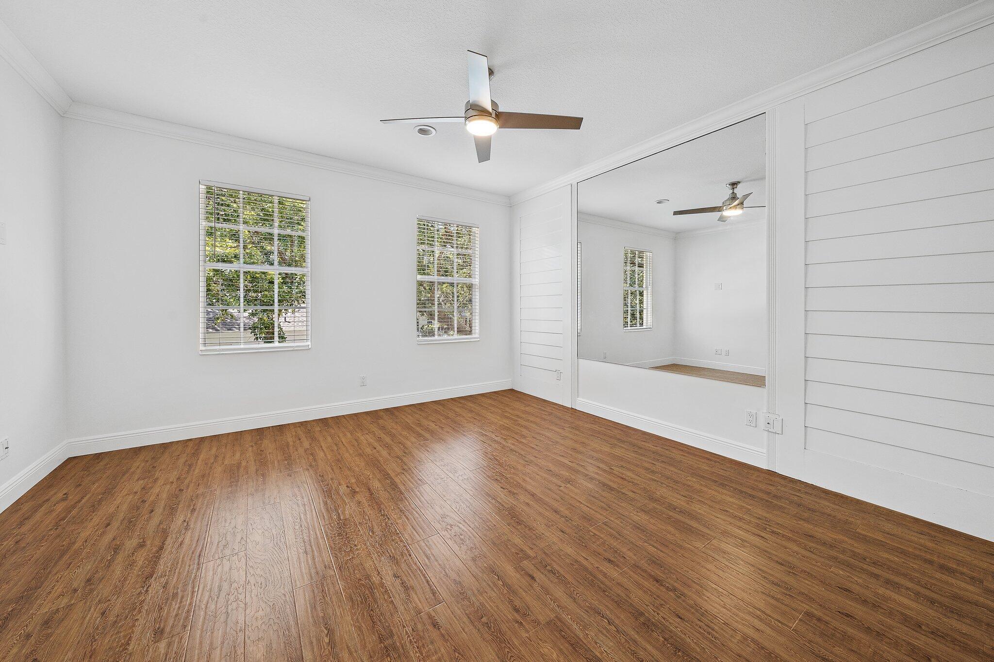 304 Legare Court Jupiter, FL 33458 - Photo 18 of 38 a view of an empty room with wooden floor and a window