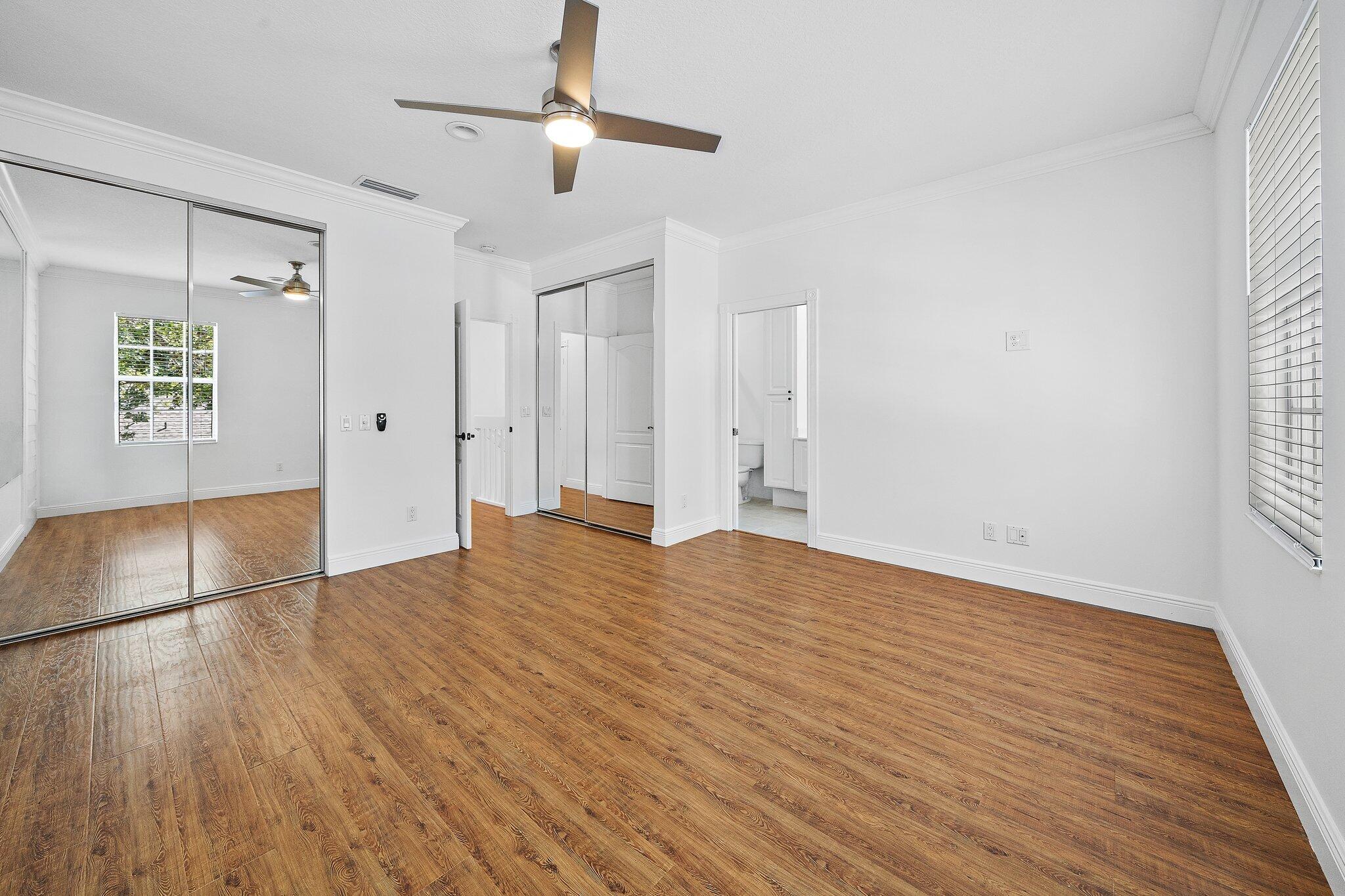 304 Legare Court Jupiter, FL 33458 - Photo 21 of 38 a view of empty room with wooden floor and fan