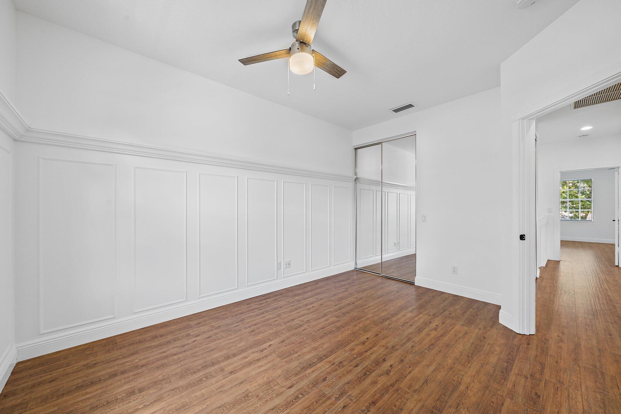 304 Legare Court Jupiter, FL 33458 - Photo 26 of 38 a view of an empty room with wooden floor