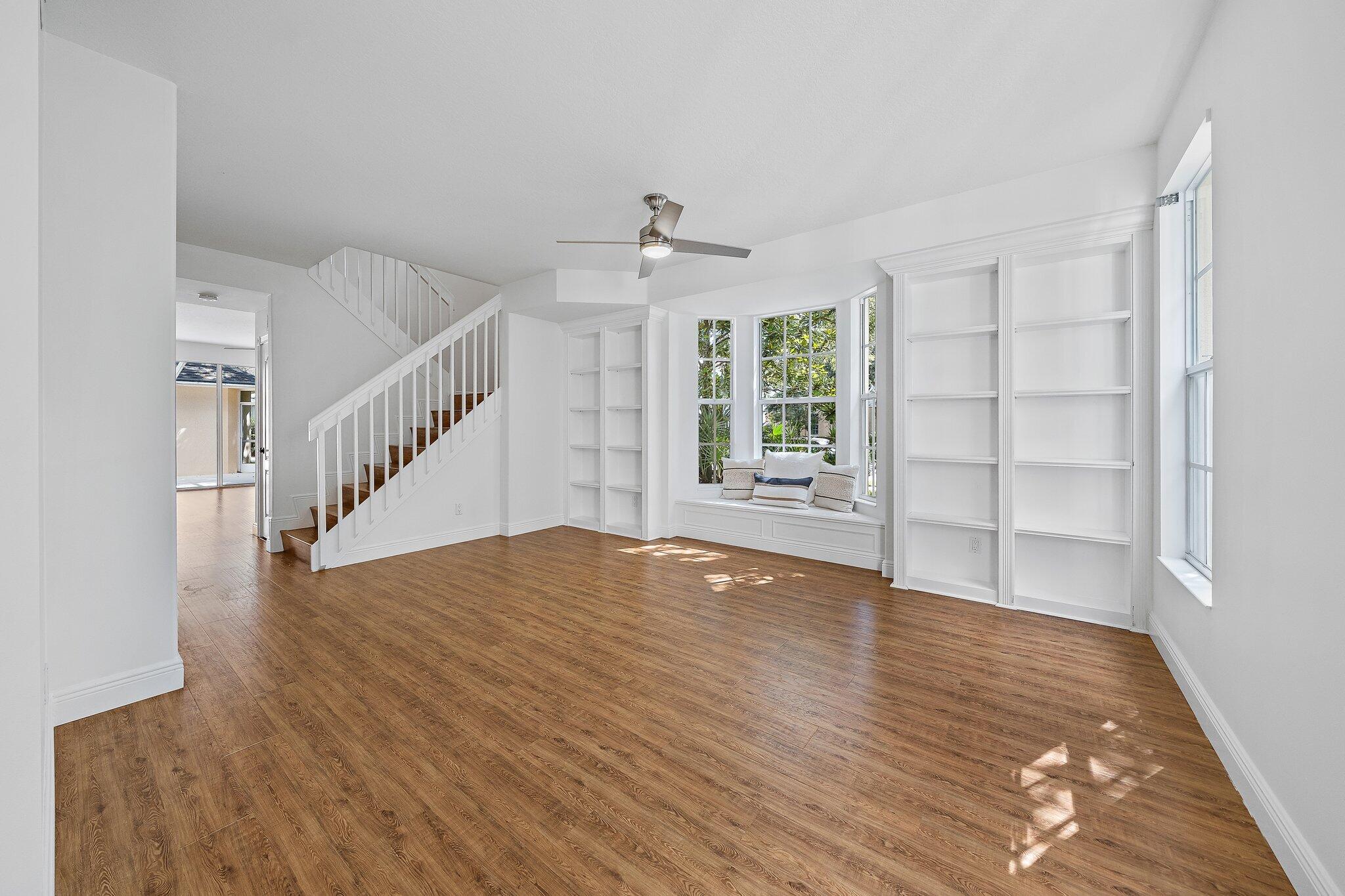 304 Legare Court Jupiter, FL 33458 - Photo 3 of 38 a view of an empty room with wooden floor and a window