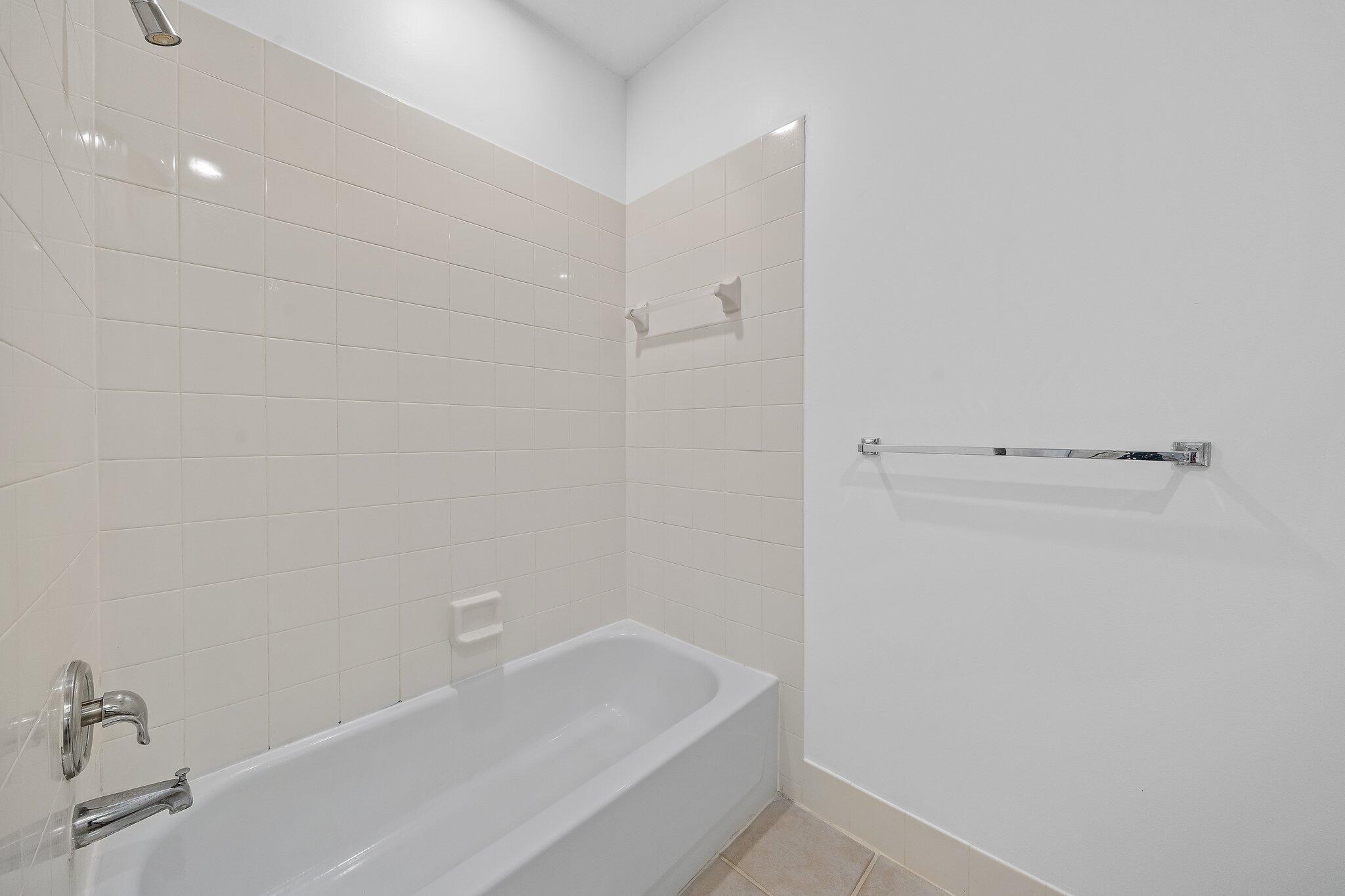 304 Legare Court Jupiter, FL 33458 - Photo 31 of 38 a bathroom with a bathtub