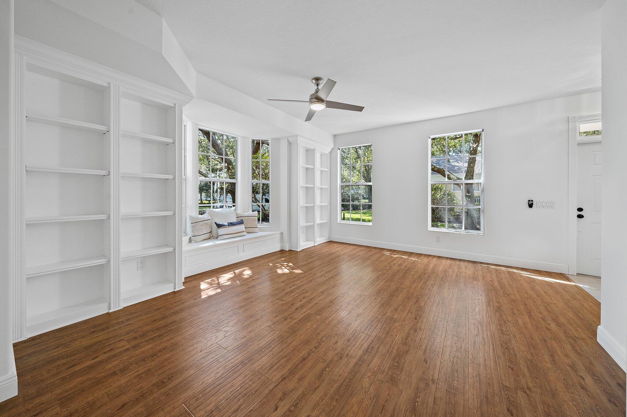 304 Legare Court Jupiter, FL 33458 - Photo 6 of 38 wooden floor in an empty room with a window