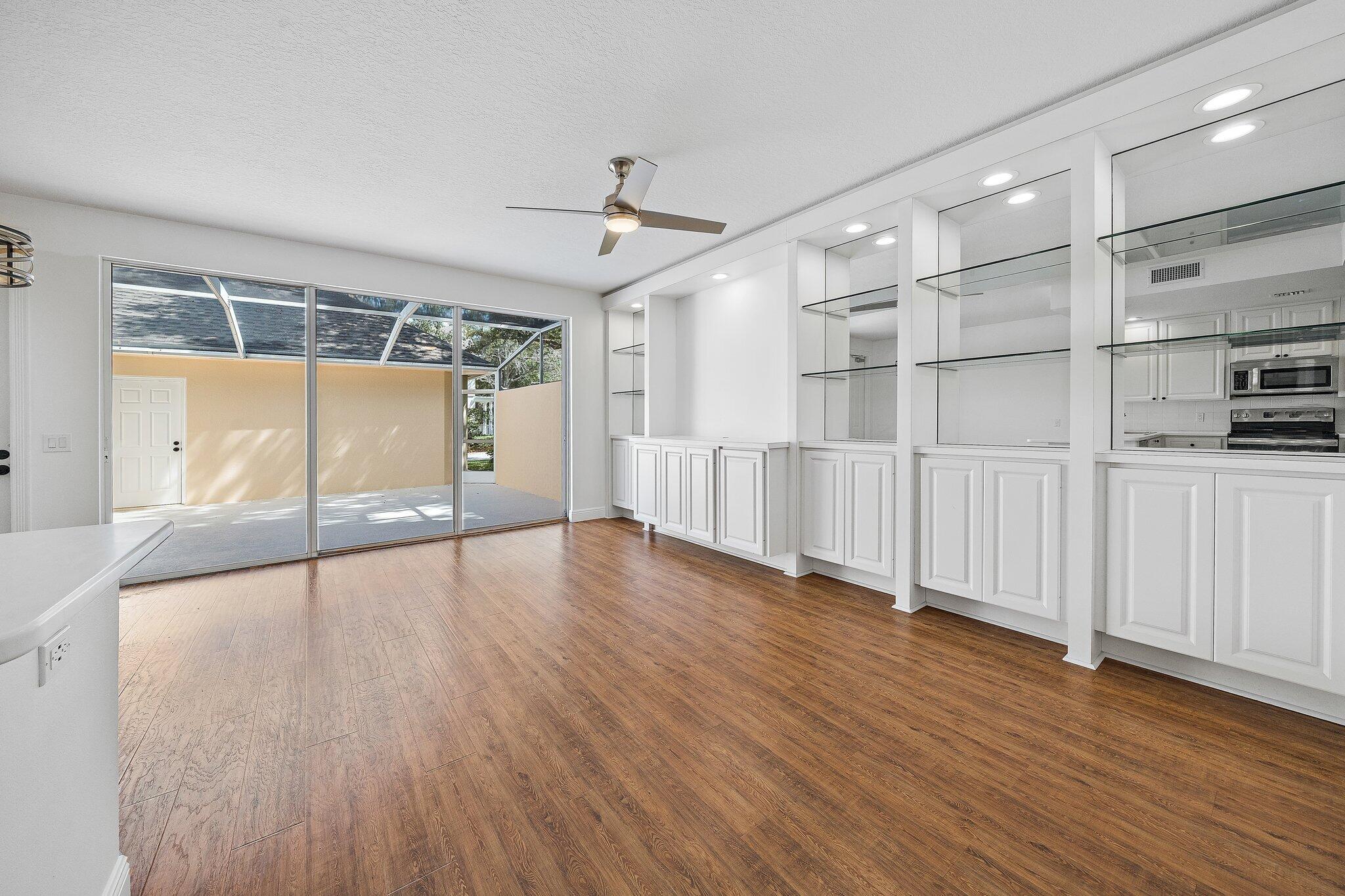 304 Legare Court Jupiter, FL 33458 - Photo 8 of 38 a view of an empty room with wooden floor and a window