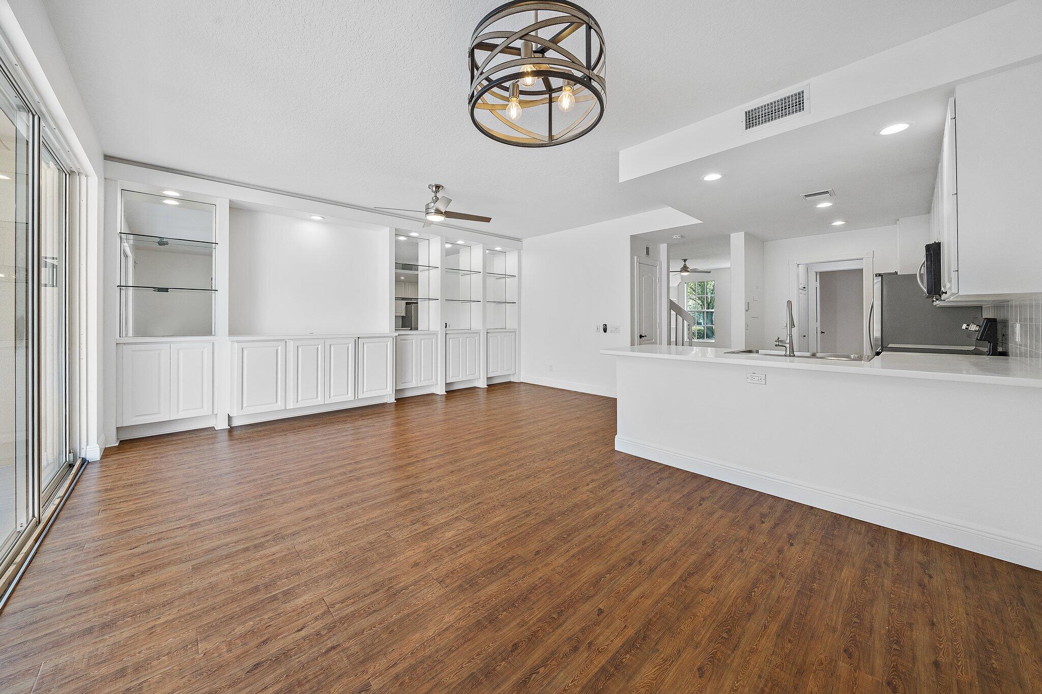 304 Legare Court Jupiter, FL 33458 - Photo 10 of 38 a view of kitchen and hall with wooden floor