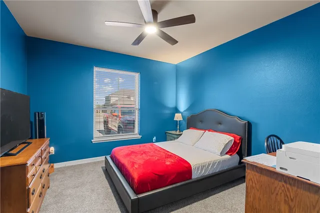 a bedroom with a bed and a television