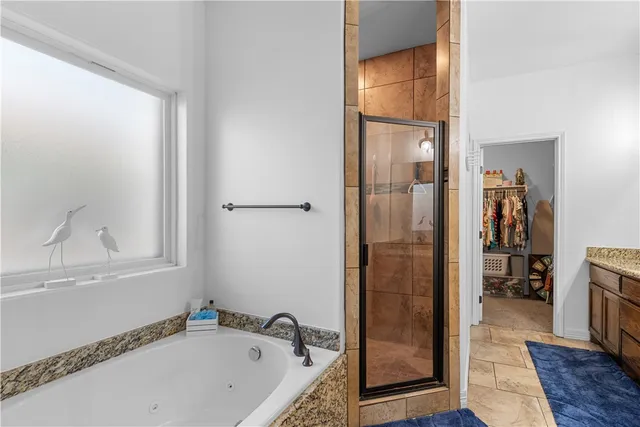 a bathroom with a tub and a shower