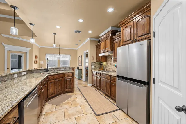 a kitchen with refrigerator and cabinets