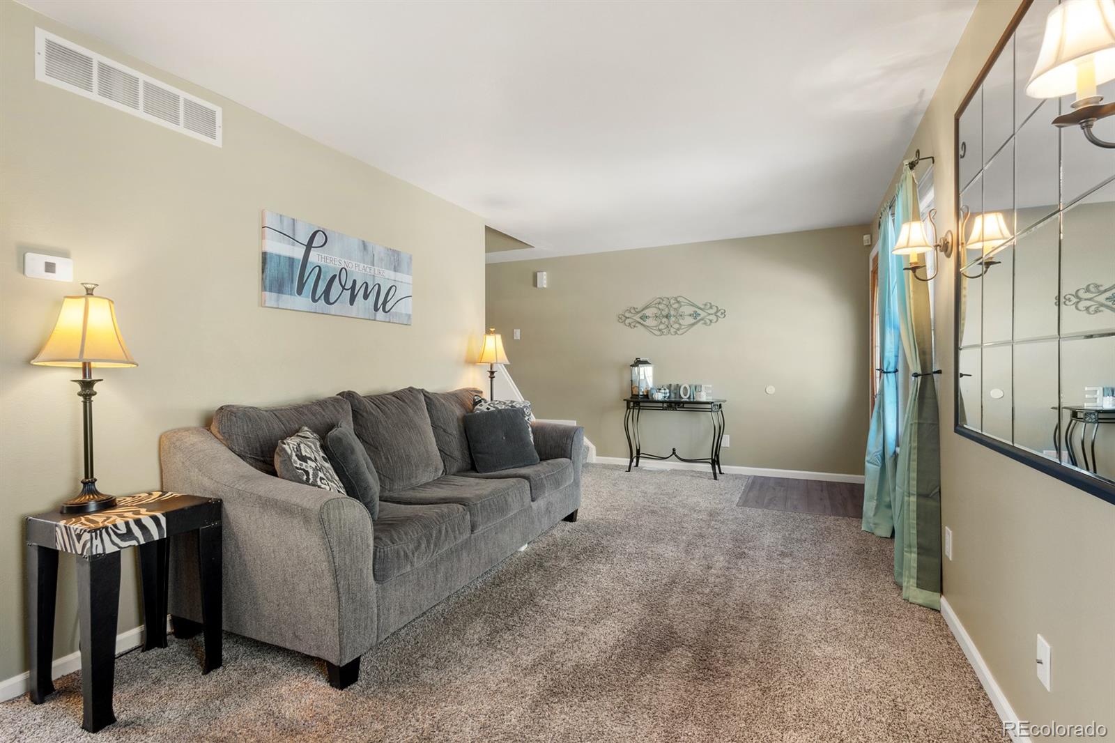 a living room with furniture and a lamp
