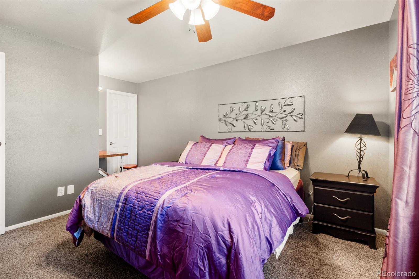 4262 South Quintero Way Aurora, CO 80013 - Photo 12 of 36 a bedroom with a bed and wooden floor