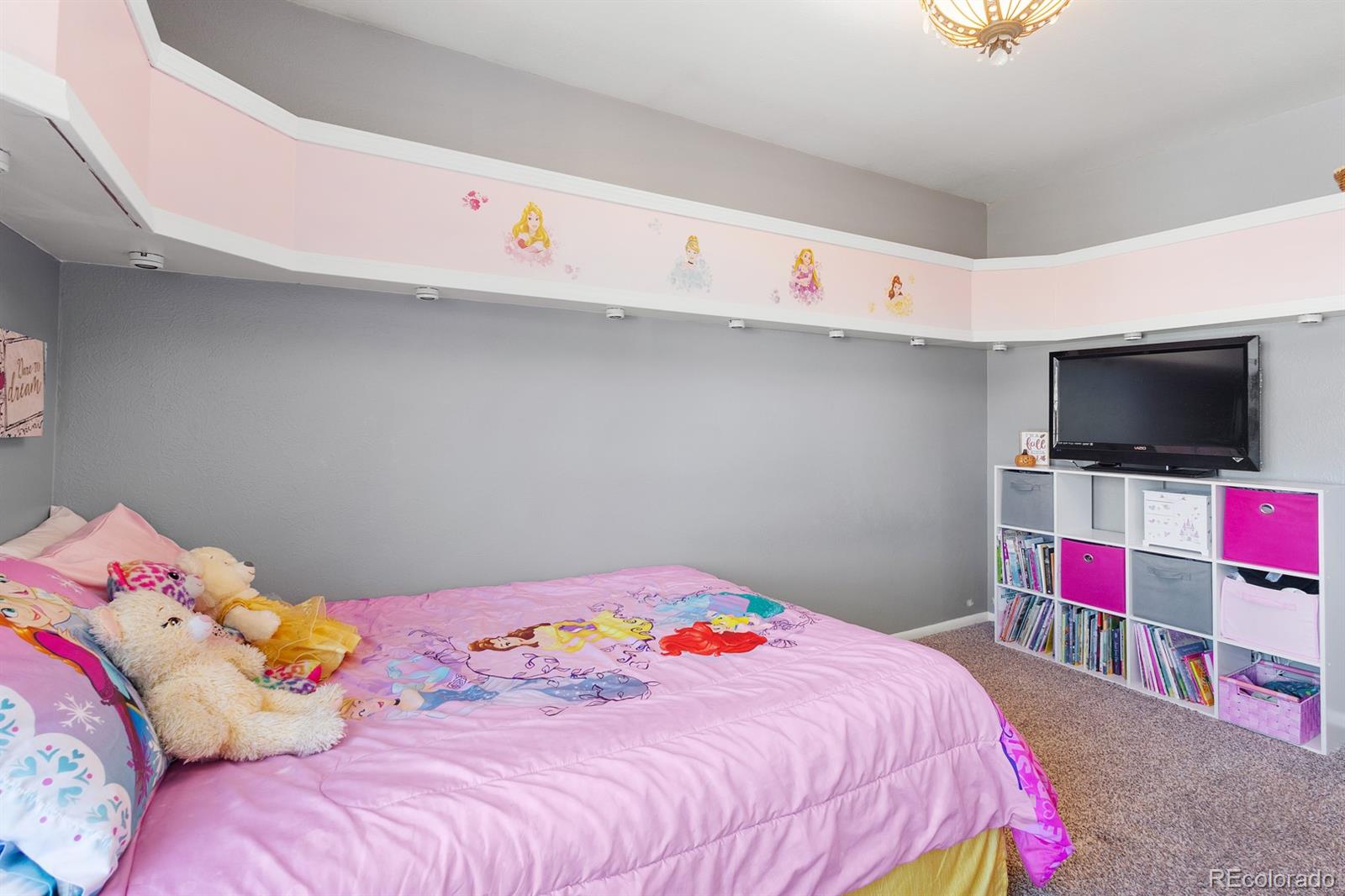 4262 South Quintero Way Aurora, CO 80013 - Photo 16 of 36 a bedroom with a bed and a flat screen tv