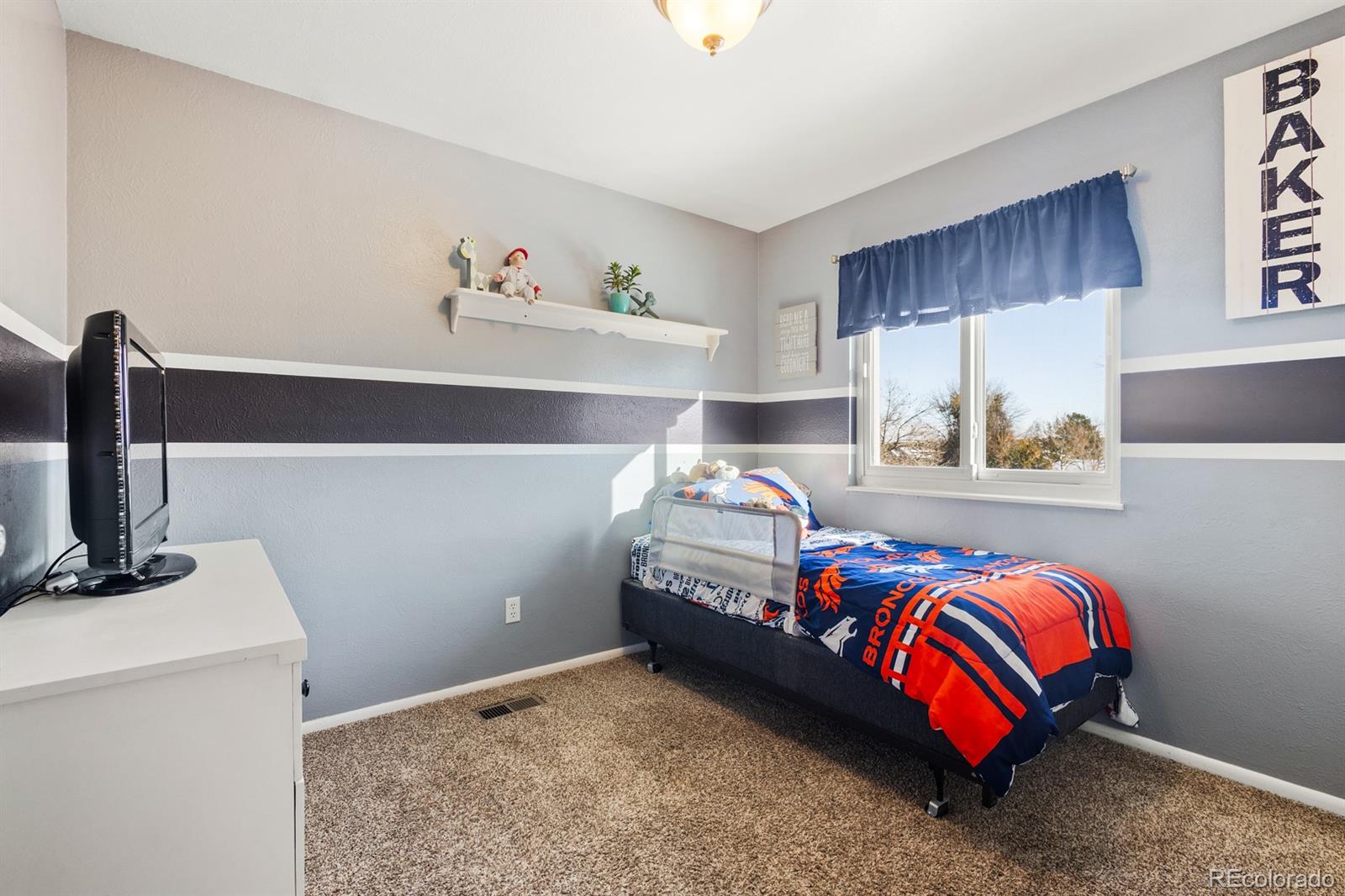 4262 South Quintero Way Aurora, CO 80013 - Photo 17 of 36 a bedroom with a bed and a cabinets
