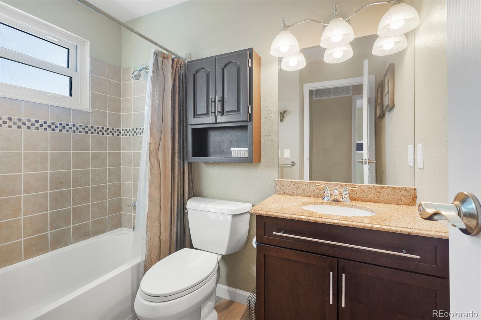 4262 South Quintero Way Aurora, CO 80013 - Photo 19 of 36 a bathroom with a sink a toilet and shower