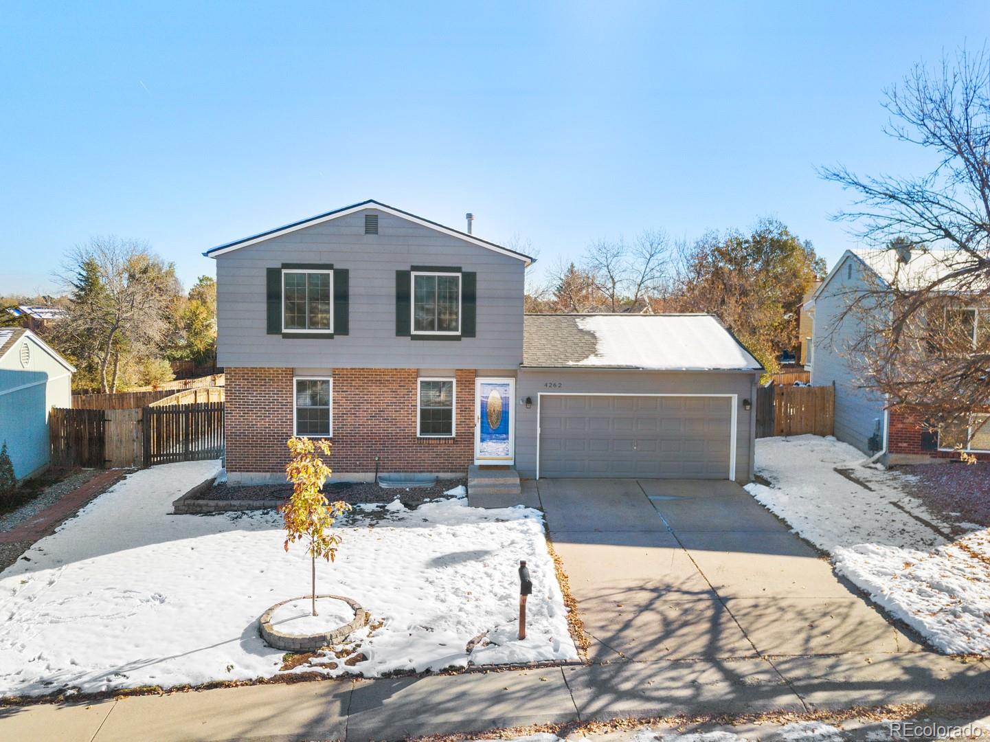 4262 South Quintero Way Aurora, CO 80013 - Photo 2 of 36 a front view of a house with a yard