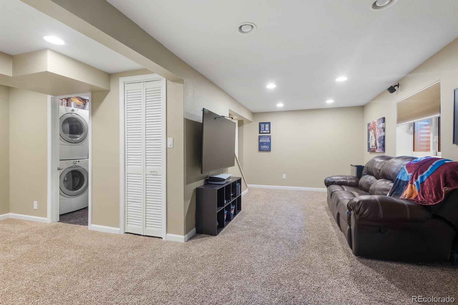 4262 South Quintero Way Aurora, CO 80013 - Photo 22 of 36 a living room with furniture and a flat screen tv