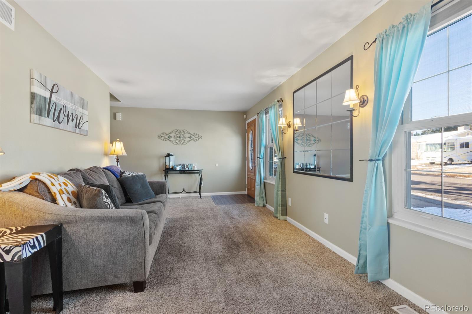 4262 South Quintero Way Aurora, CO 80013 - Photo 4 of 36 a living room with furniture and a window