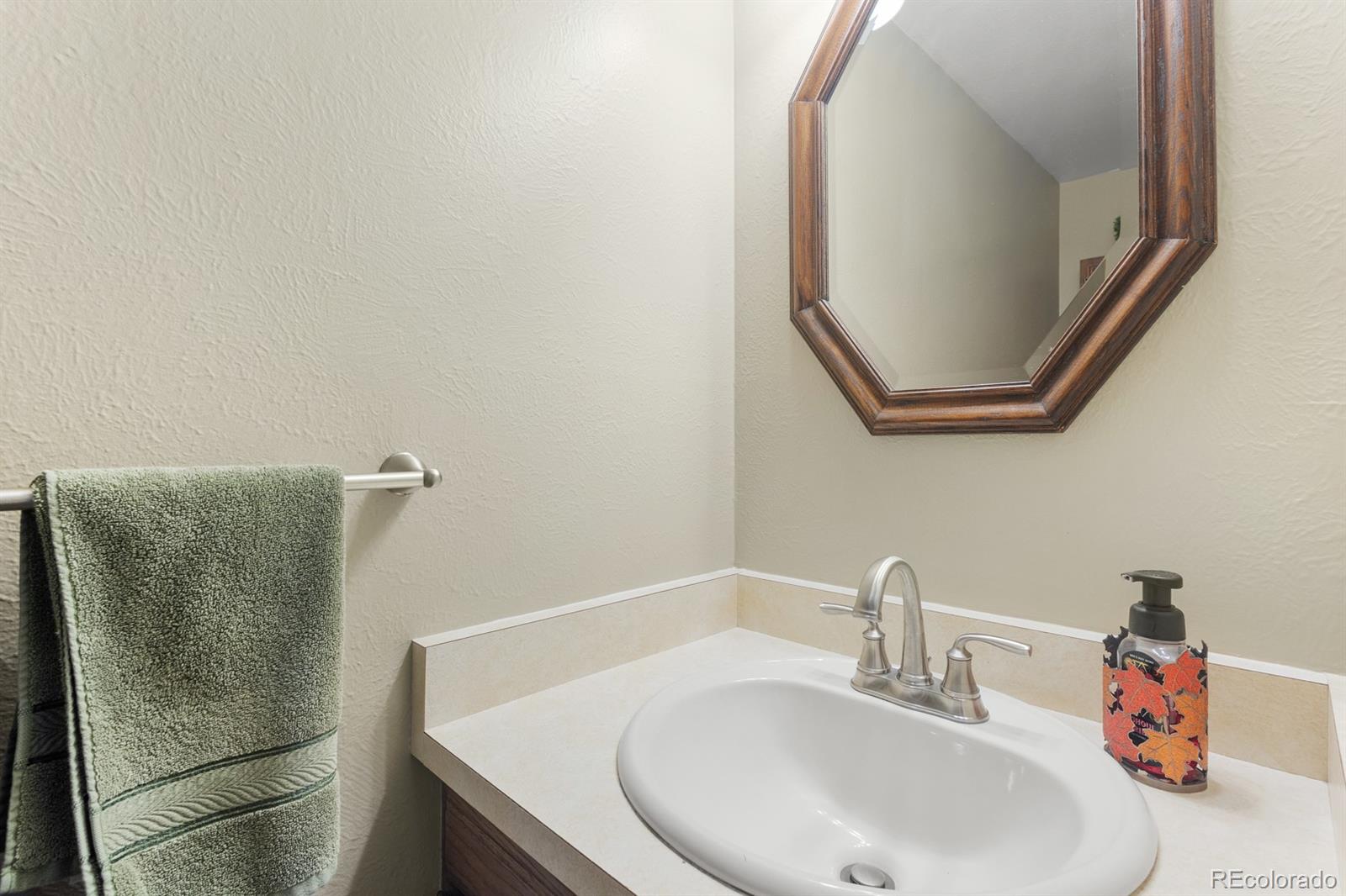 4262 South Quintero Way Aurora, CO 80013 - Photo 10 of 36 a bathroom with a sink and a mirror