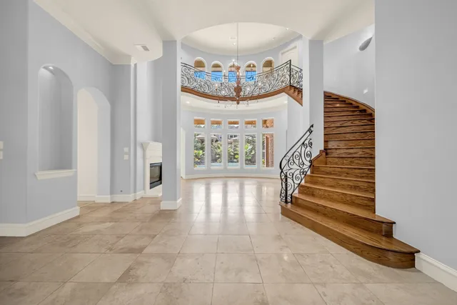 a kitchen with stainless steel appliances kitchen island granite countertop a refrigerator and a stove top oven