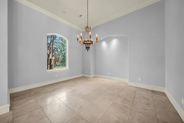 a view of a chandelier in big room and chandelier fan