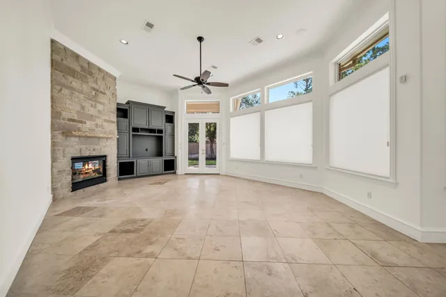 a view of empty room with a fireplace and window