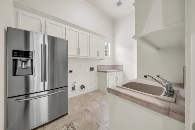 a white refrigerator freezer sitting in a kitchen
