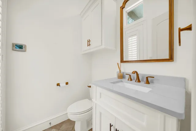 a bathroom with a sink toilet and a mirror