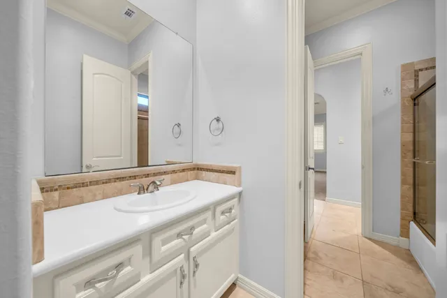 a bathroom with a sink and a mirror