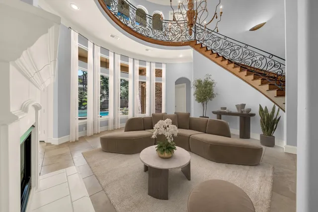 a dining room with furniture potted plants and wooden floor