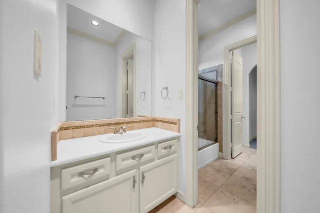 a bathroom with a sink vanity and a mirror