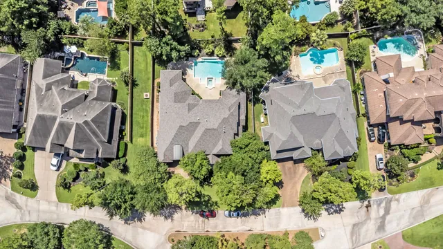 an aerial view of a house with a yard and garden