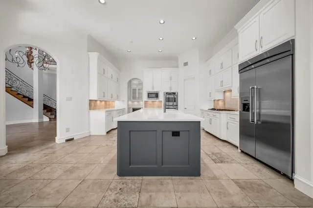 a kitchen with stainless steel appliances a sink stove and refrigerator