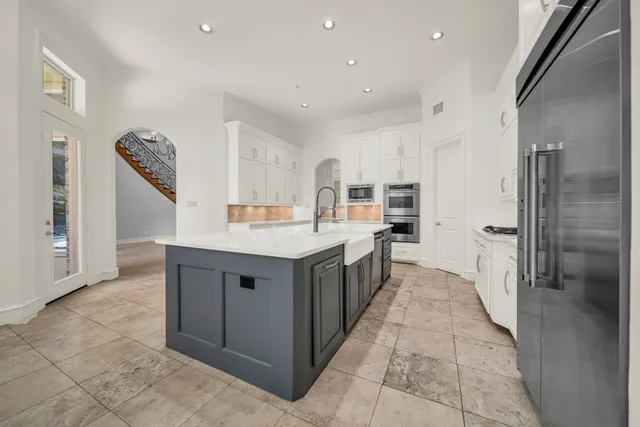a kitchen with kitchen island cabinets and refrigerator