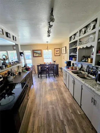 a kitchen with a table chairs stove and cabinets