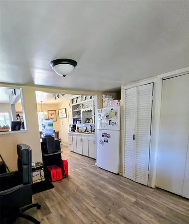 a view of a livingroom with workspace and a window