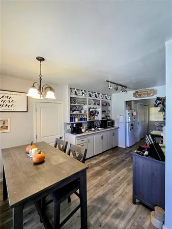 a view of a dining room with furniture and wooden floor