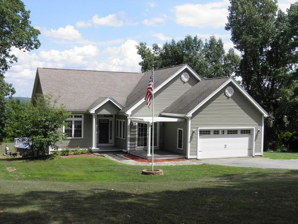 115 Fisherdick Road Ware, MA 01082 - Photo 1 of 30 a front view of a house with a garden and trees