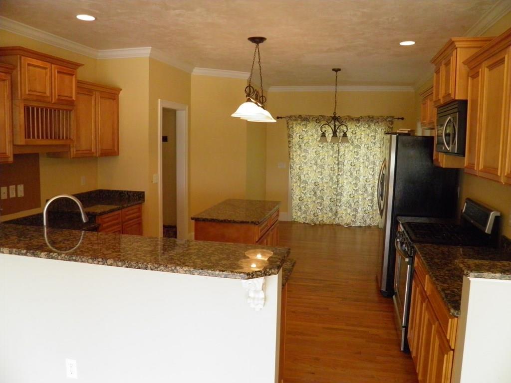 115 Fisherdick Road Ware, MA 01082 - Photo 27 of 30 a kitchen with stainless steel appliances granite countertop a refrigerator a stove and a sink