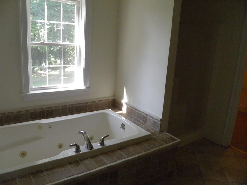 115 Fisherdick Road Ware, MA 01082 - Photo 5 of 30 a bath tub sitting next to a window