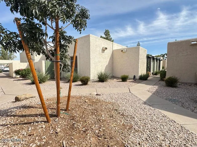 a front view of a building with garden