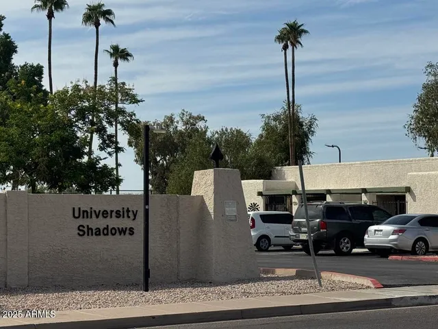 a bedroom with a bed and a mirror
