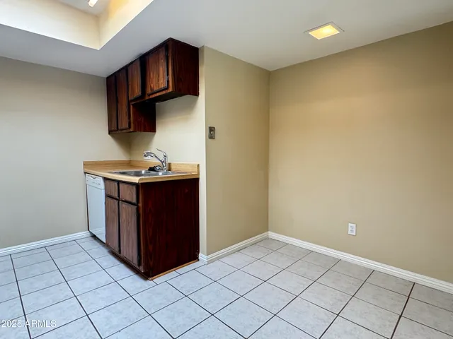 a kitchen with a sink cabinets and appliances